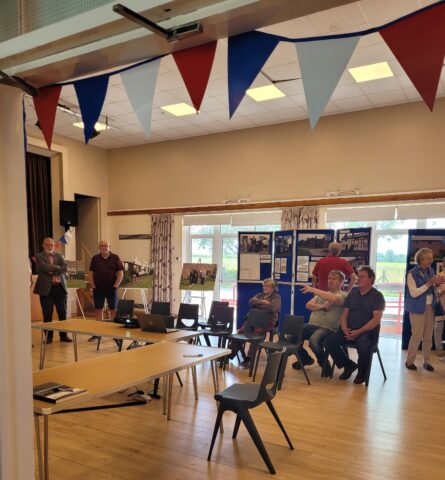People in the village hall viewing an exhibition